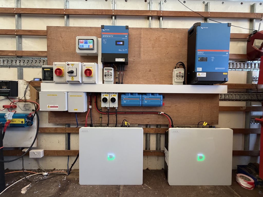 Off-grid installation showing a Victron MultiPlus-II, RS450 solar controller, display, switching and two Dyness batteries